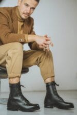 Close-up of black Samelin M77 Norwegian combat boots in full-grain leather worn with casual outfit, highlighting rugged design