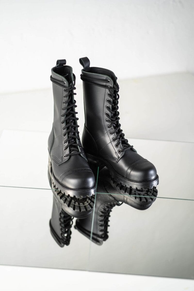 Black high aviator leather boots pair front angled view with lace-up design, reinforced toe, and rugged lug sole for durable military-style wear
